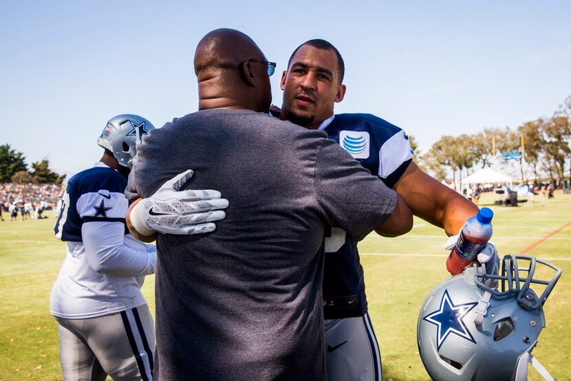 Dallas Cowboys defensive tackle Tyrone Crawford hugs Former Dallas Cowboys linebacker...