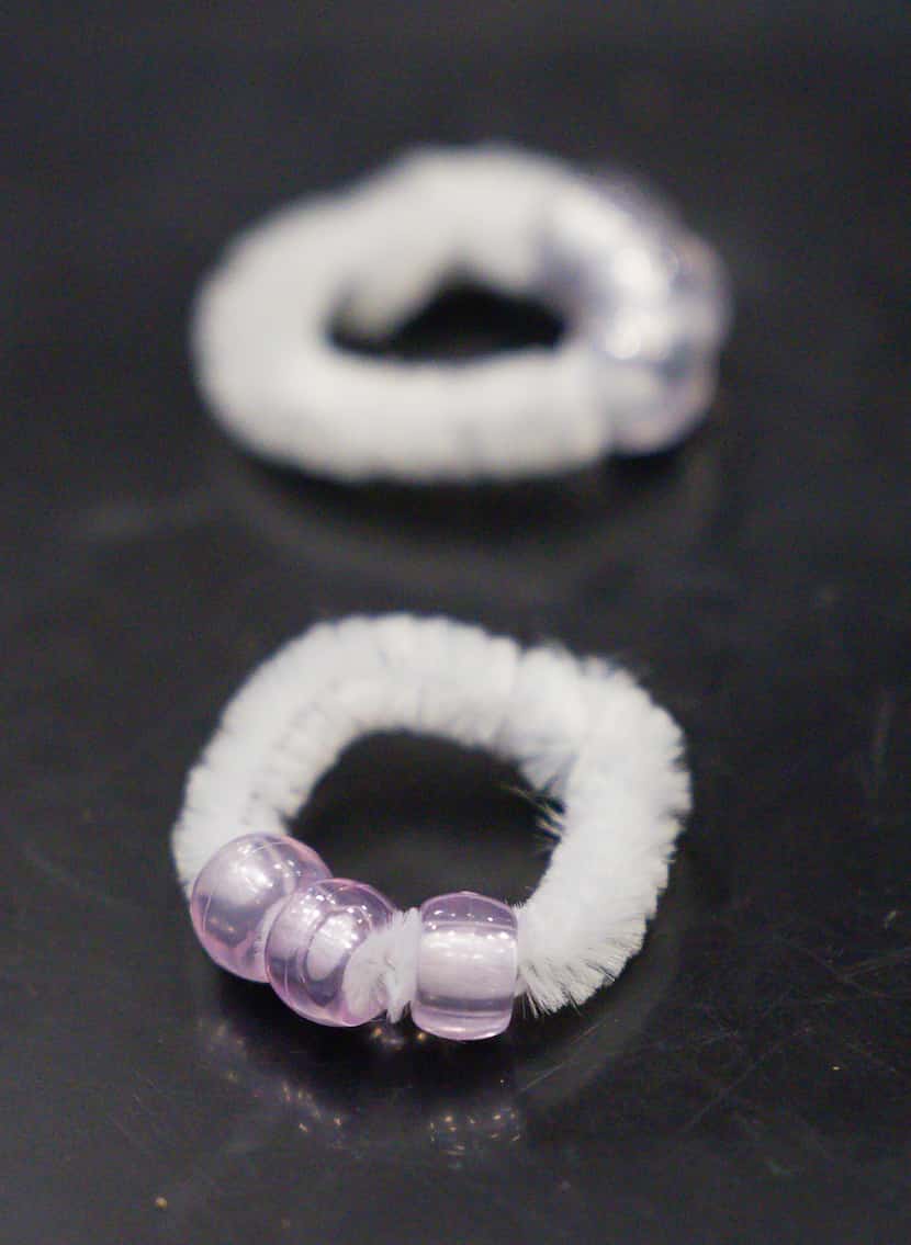 UV beads turn purple after reacting with UV light during a science activity as part of GSK...