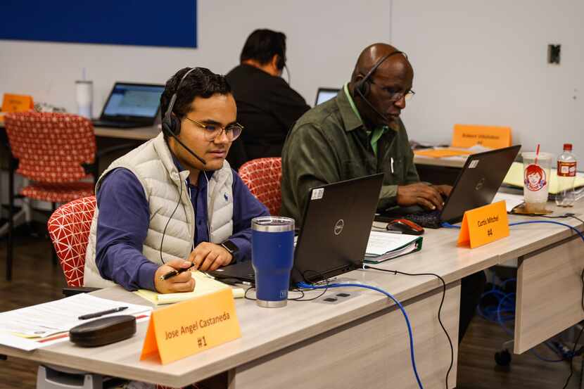 Phone operators Jose Angel Castaneda, left, and Curtis Mitchell work to monitor the midterm...