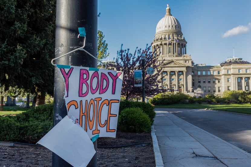 FILE - A sign reading "My body, my Choice," is taped to a hanger taped to a streetlight in...