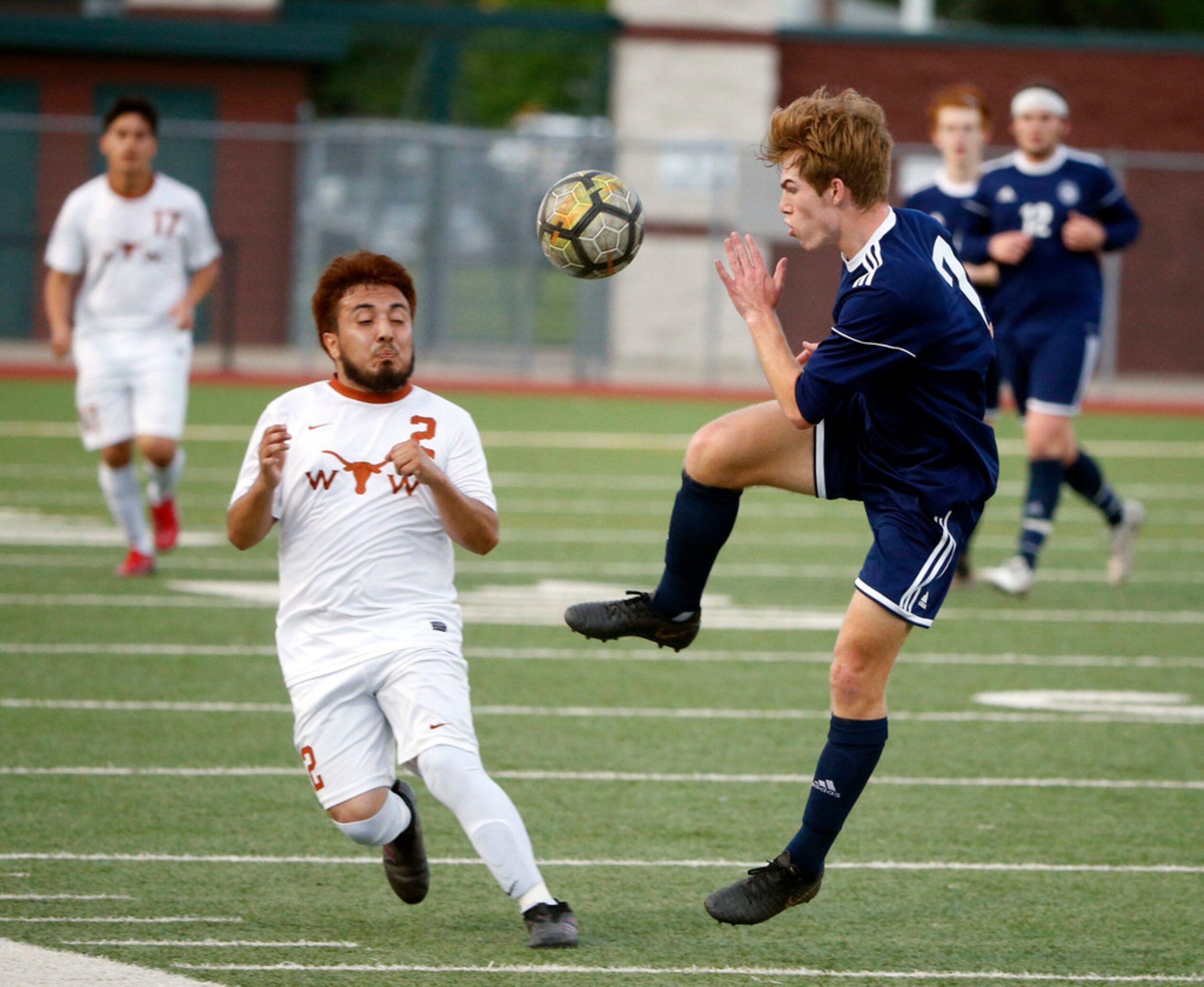 W.T, White's Jorge Juarez (2) and Flower Mound's Shane Popieluch (7) fight for the ball...