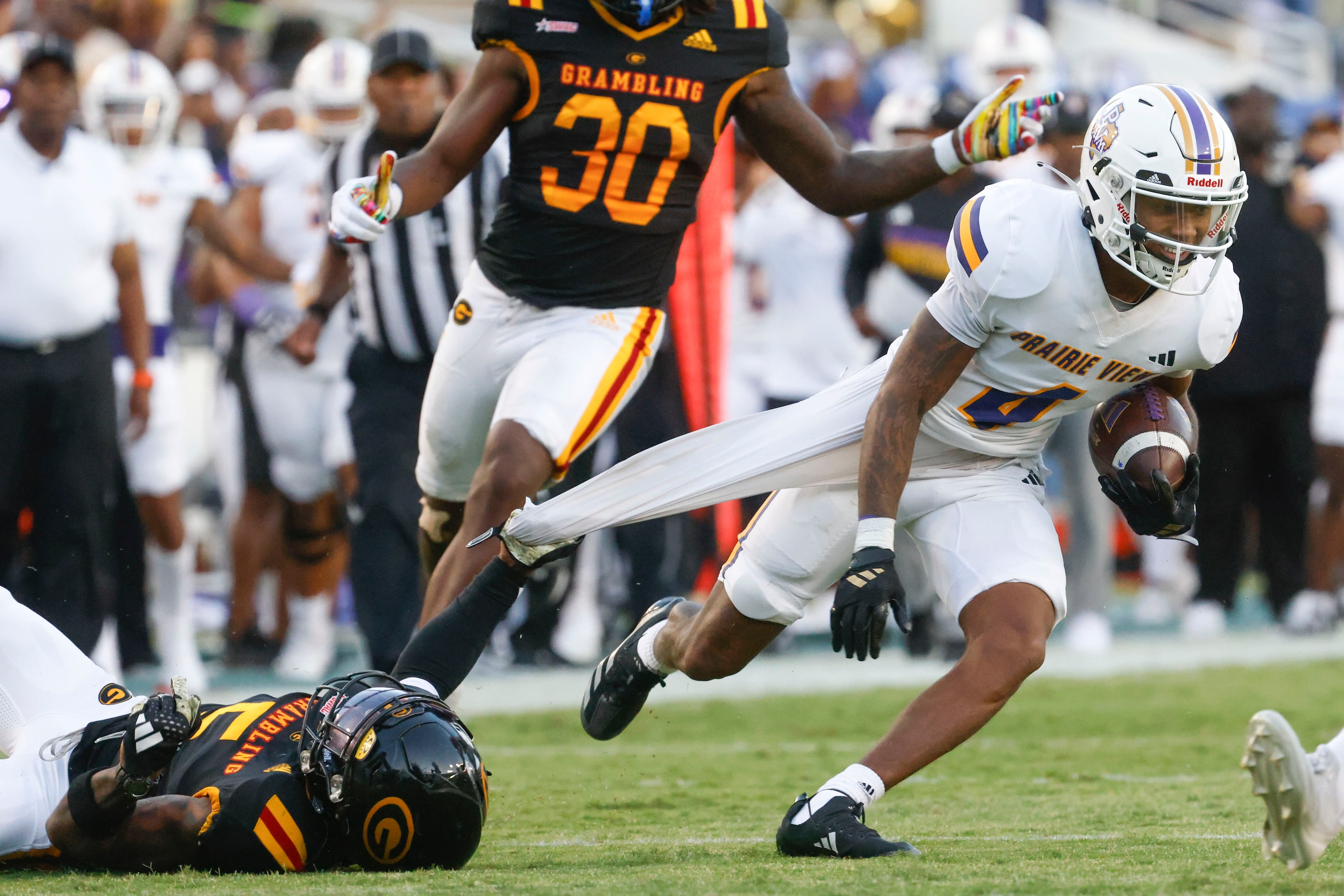 Grambling State defensive back Calvin Henderson (left) holds on to Prairie View A&M wide...