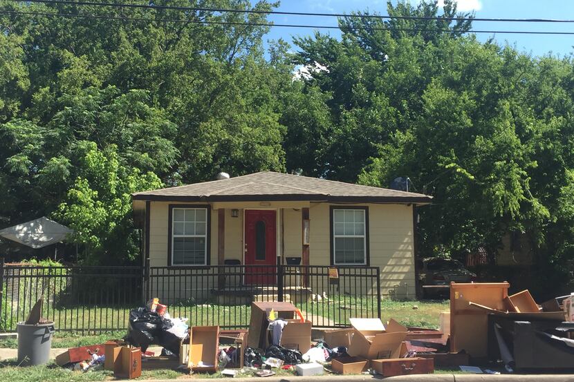 Dumped furniture and clothing lines the sidewalk in front of the Morris Street house where...