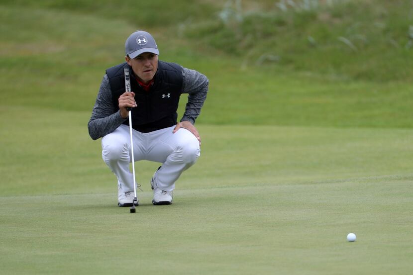 Jordan Spieth of the United States lines up a putt on the 14th hole during the first round...