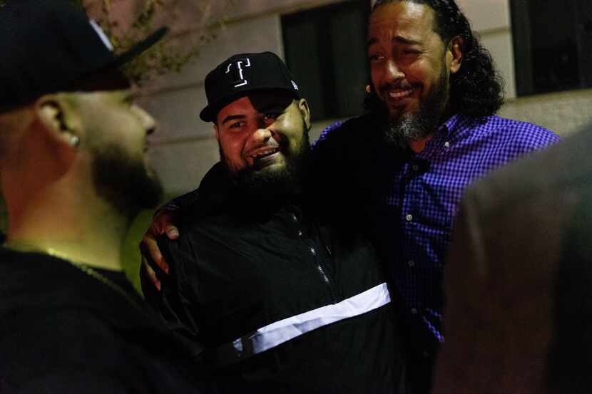 Brandon Ray Gonzales (center), 23, receives a hug from his cousin, the Rev. Philip Williams...