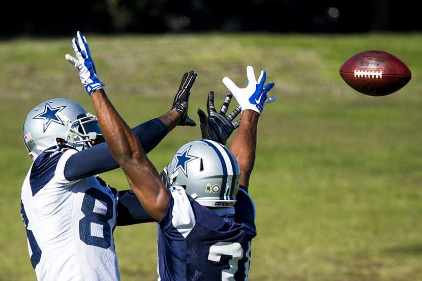Dallas Cowboys wide receiver Dez Bryant (88) catches a pass despite the defense from free...