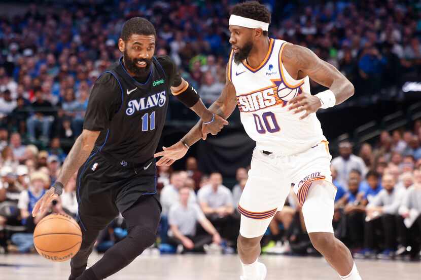 Dallas Mavericks guard Kyrie Irving (11) dribbles against Phoenix Suns forward Royce O'Neale...