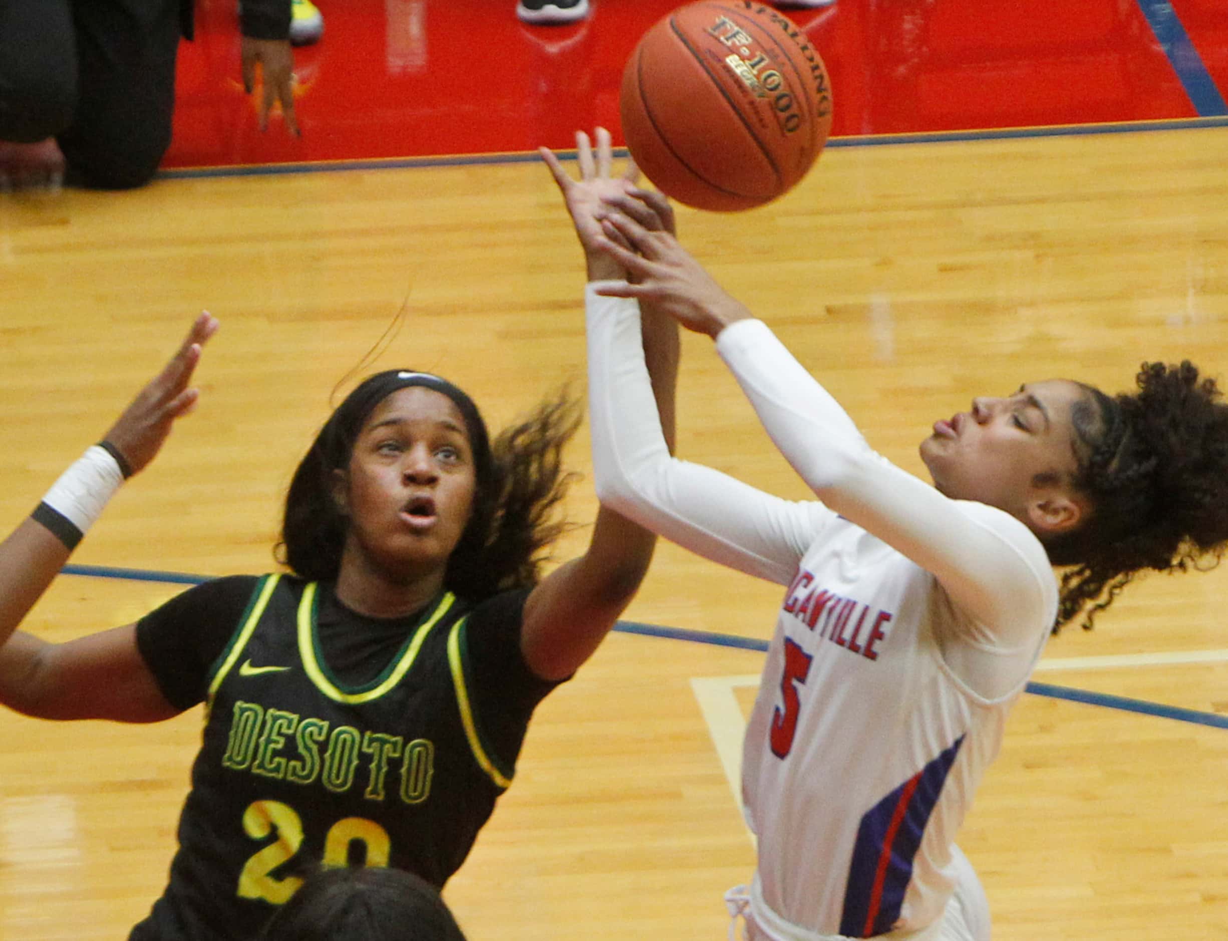 Duncanville guard Victoria Flores (5), right, is fouled by DeSoto's Ayanna Thompson (20) as...
