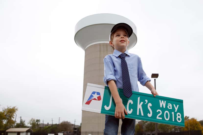 Five year-old Jack Barfield poses for a portrait as he holds up a sign he received from the...