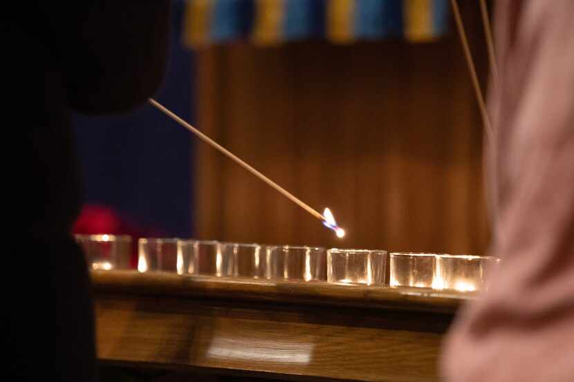 A candle is lit during Highland Park United Methodist Church's Blue Christmas serivce.