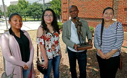 Artist Emmanuel Gillespie with the maquette of the statue and three of the students who have...