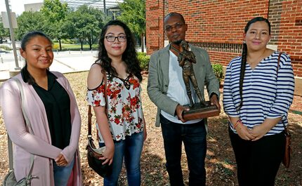 Artist Emmanuel Gillespie with the maquette of the statue and three of the students who have...