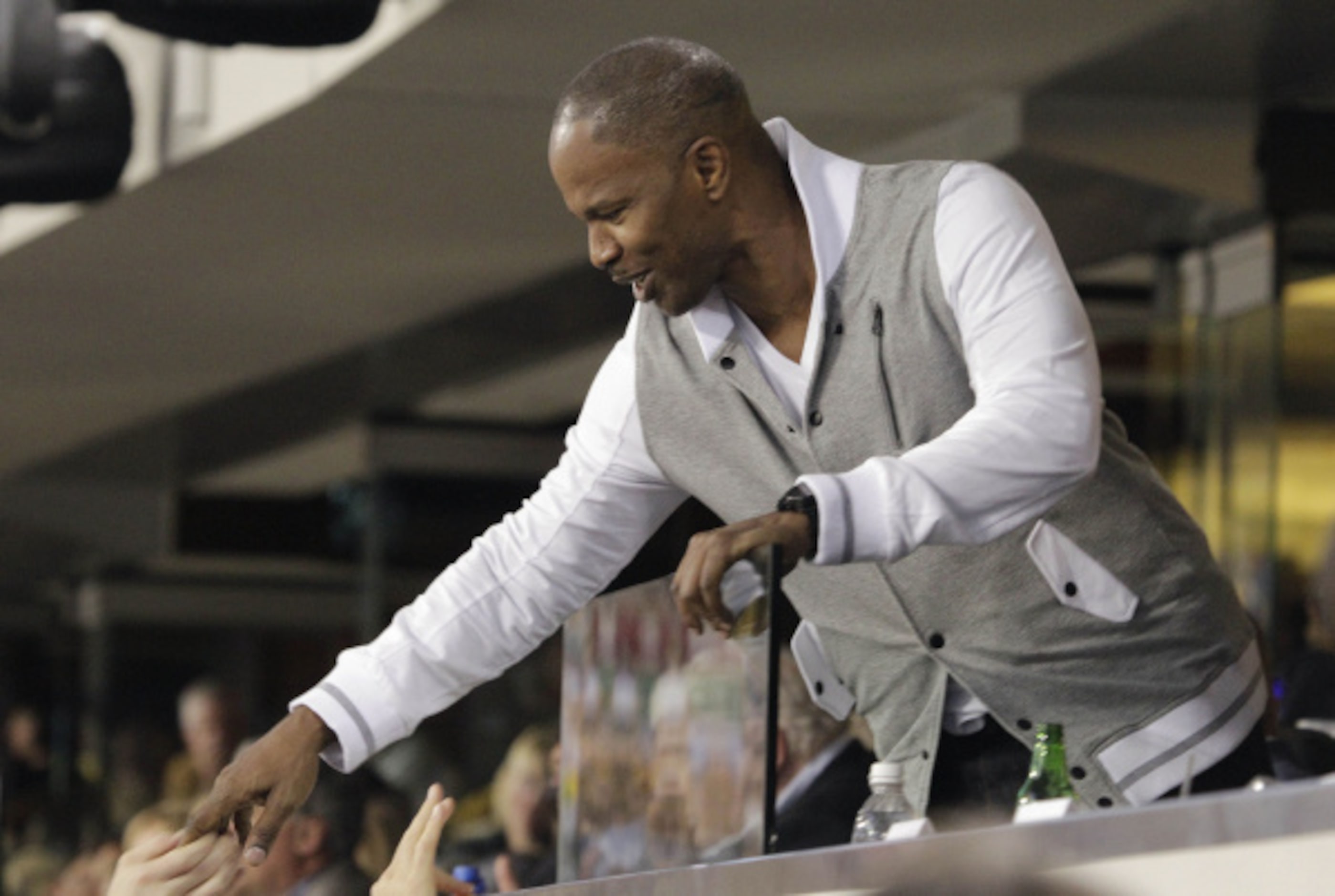 Actor Jamie Foxx greets fans at Cowboys Stadium during the first half of the NFL football...