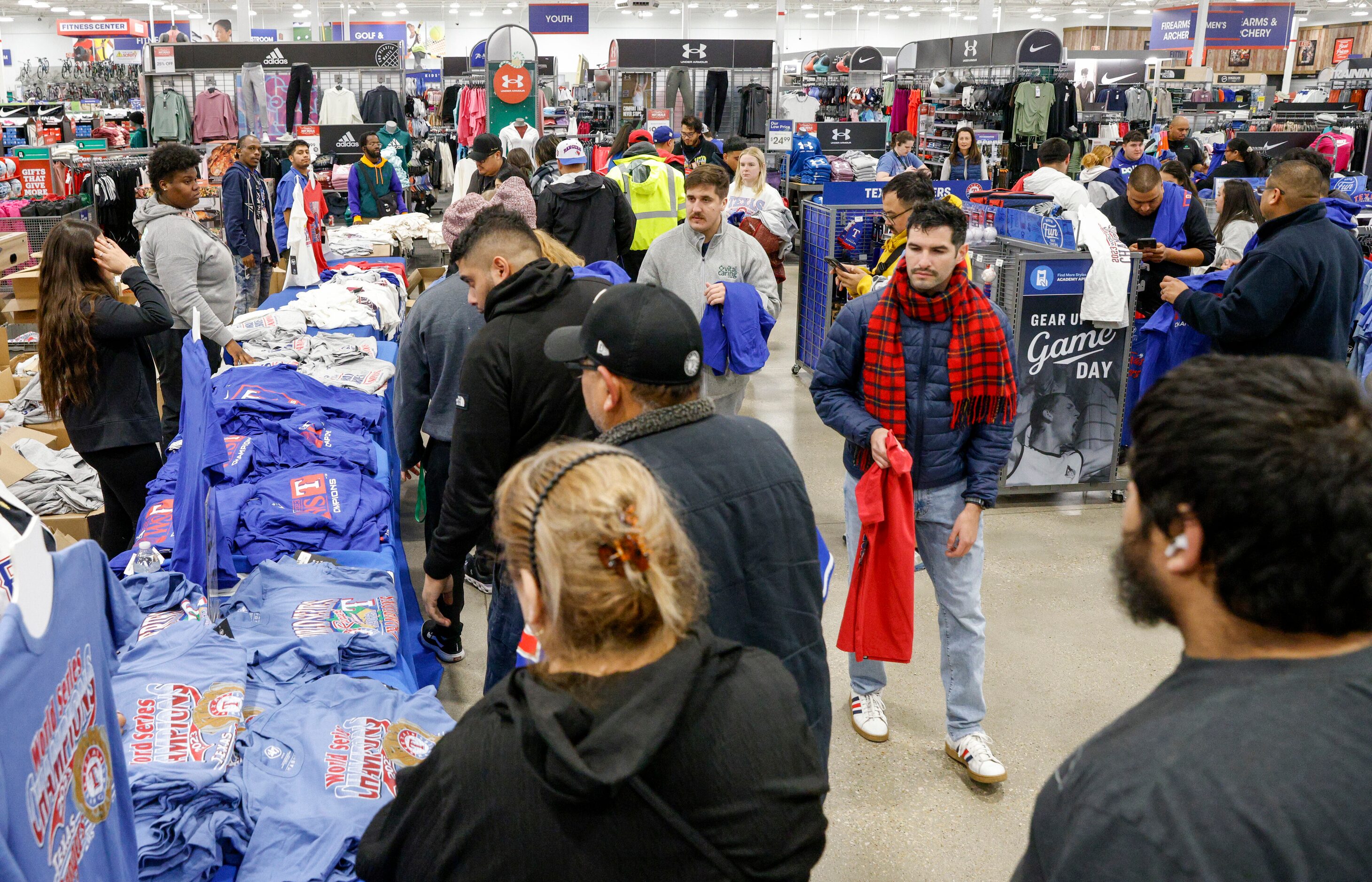 People shop for Texas Rangers World Series championship merchandise at an Academy Sports,...