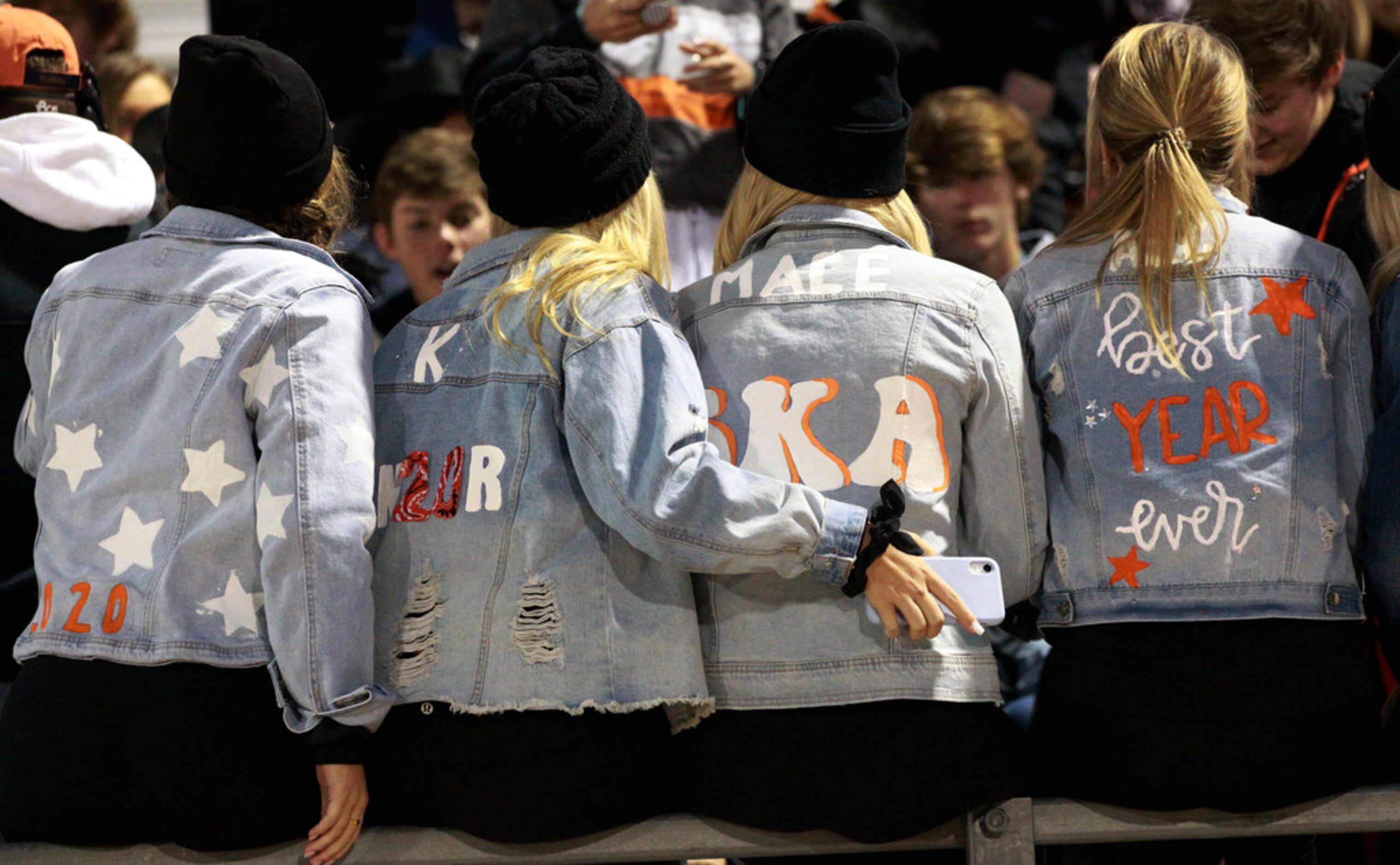 Seniors in the Rockwall student section hug, as they talk with friends, before the first...