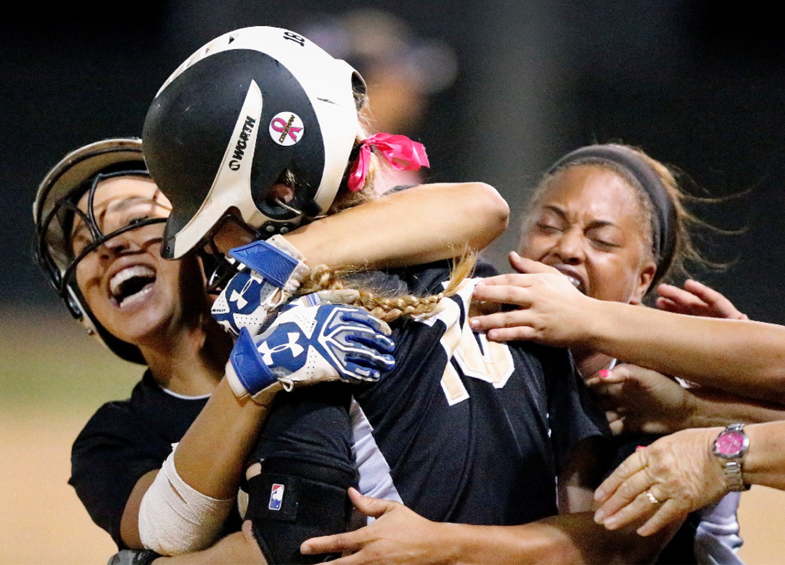 The Colony's Zariya Stiner (11) runs out with teammate Jayda Coleman (24), who hugs Madison...