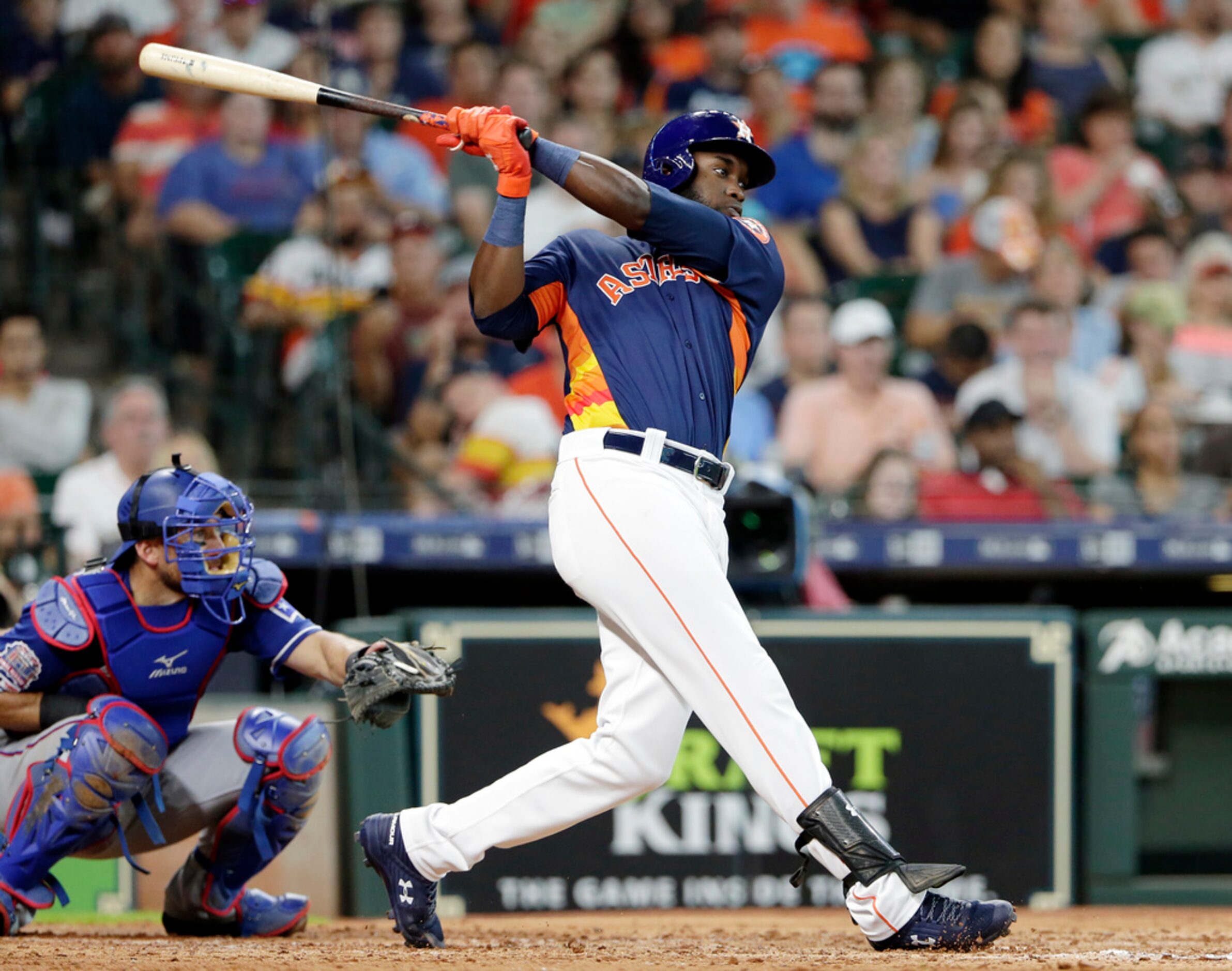 Houston Astros designated hitter Yordan Alvarez connects for an RBI-single in front of Texas...