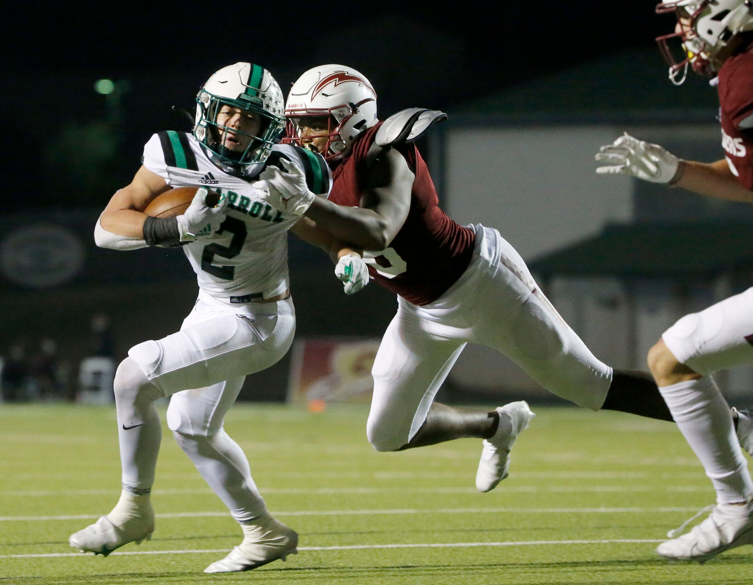 Keller Central’s Darius Graham (18) tries to tackle Southlake Carroll running back Owen...