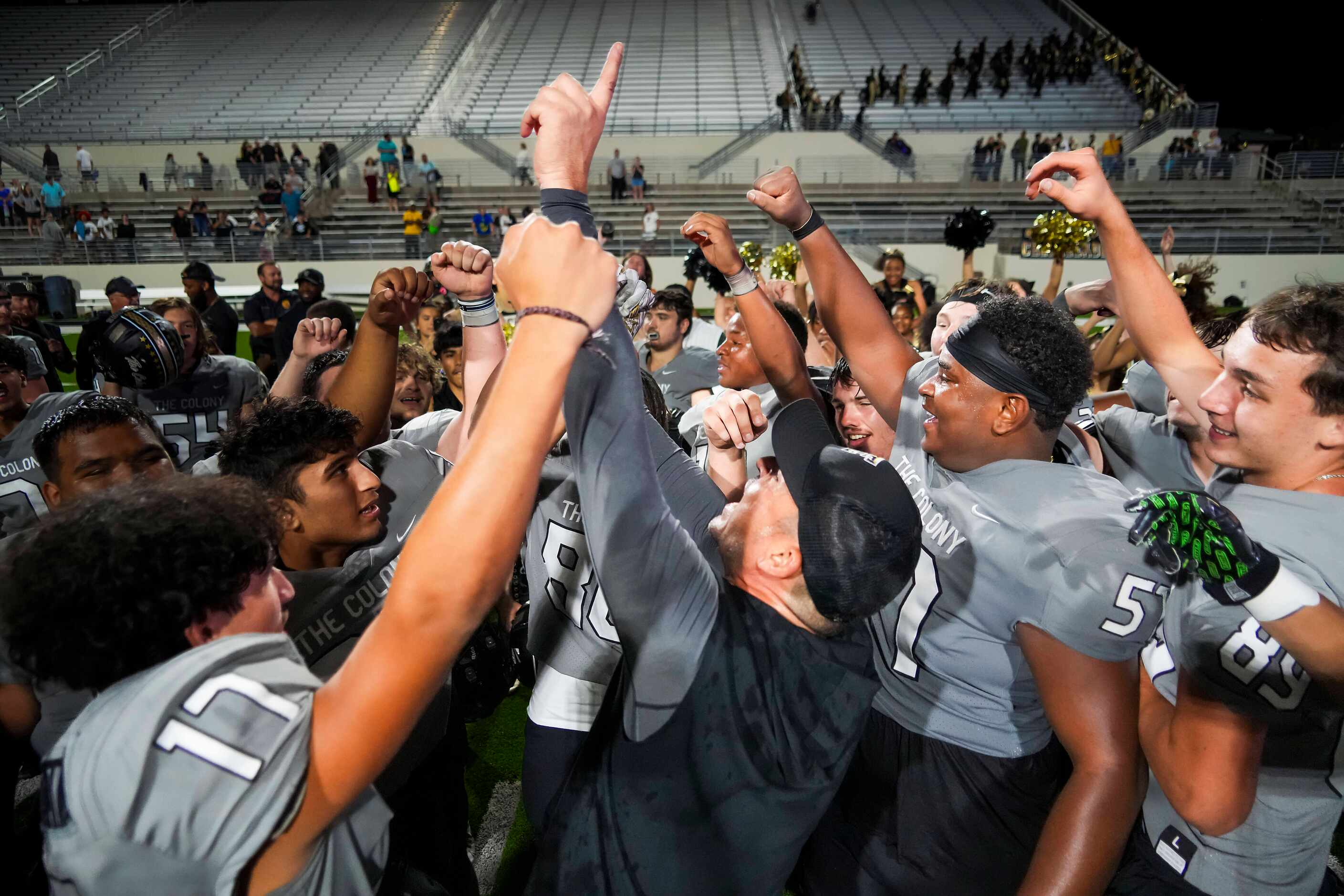 The Colony head coach Rudy Rangel celebrates with his players after a victory over Denton...