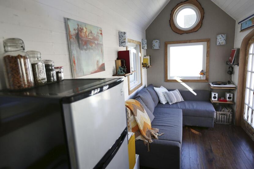 Left:  The living area of Randi and Cody Hennigan’s tiny house includes a couch with storage...