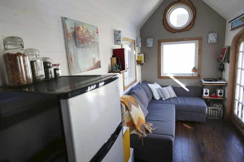 Left:  The living area of Randi and Cody Hennigan’s tiny house includes a couch with storage...