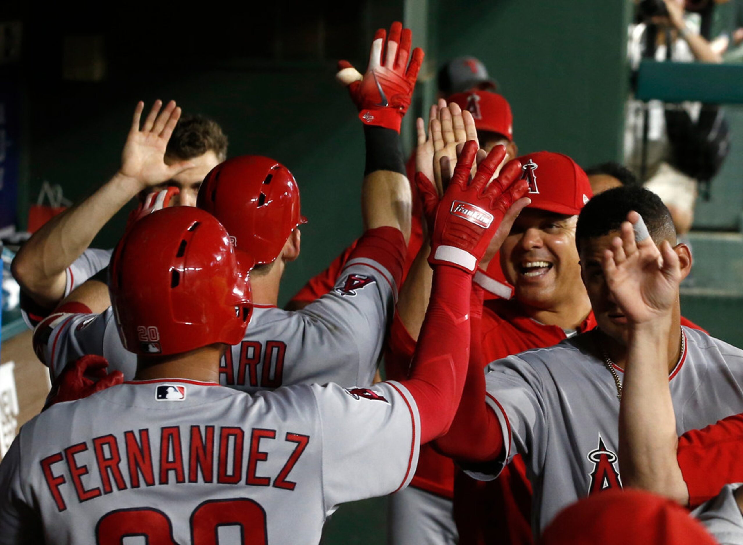 Los Angeles Angels' Jose Fernandez is congratulated by teammates after he scored on the home...