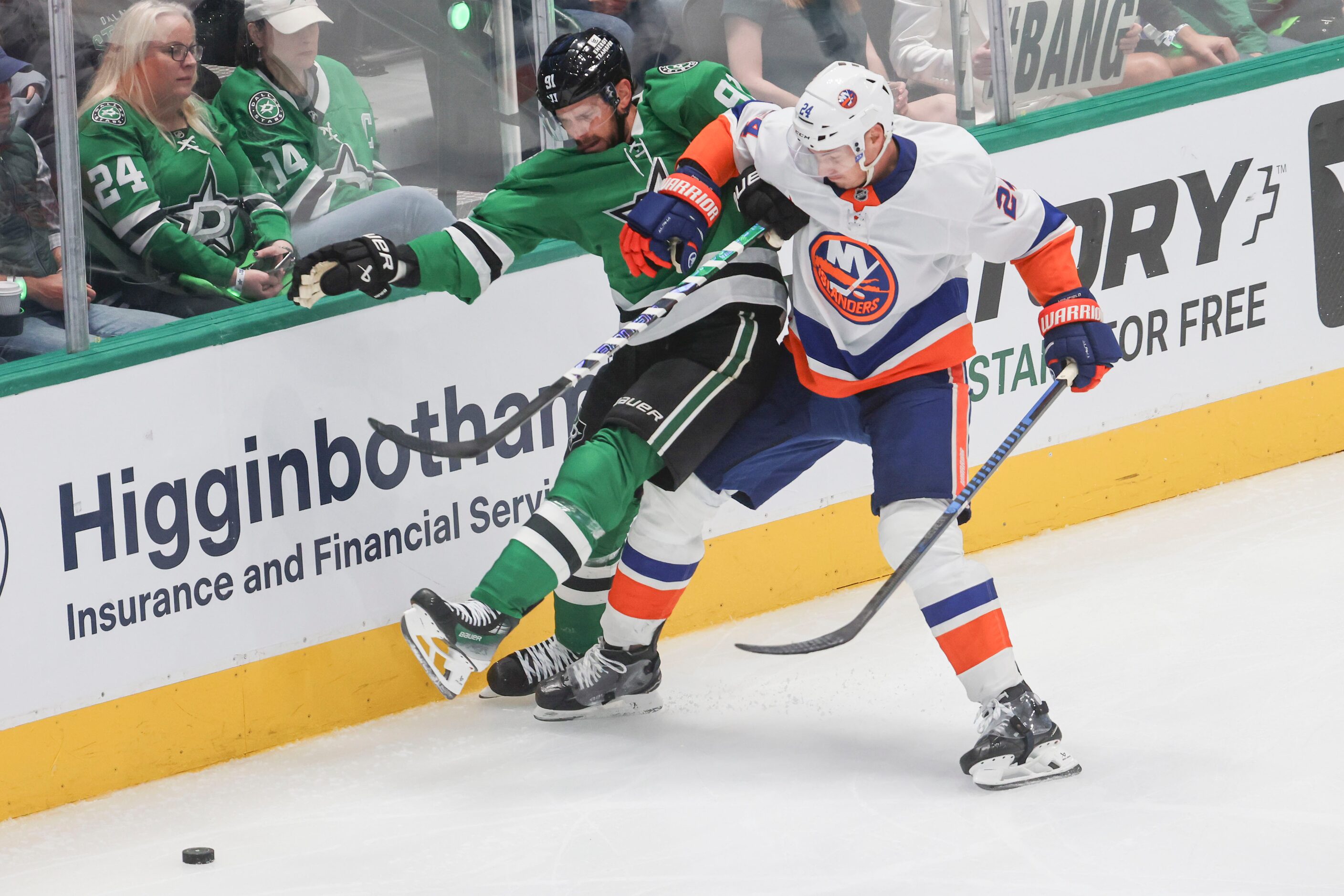 Dallas Stars center Tyler Seguin (left) gets blocked by New York Islanders defenseman Scott...