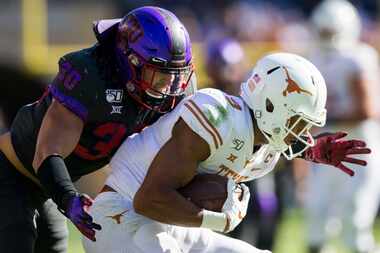 TCU Horned Frogs linebacker Garret Wallow (30) tackles Texas Longhorns wide receiver Collin...