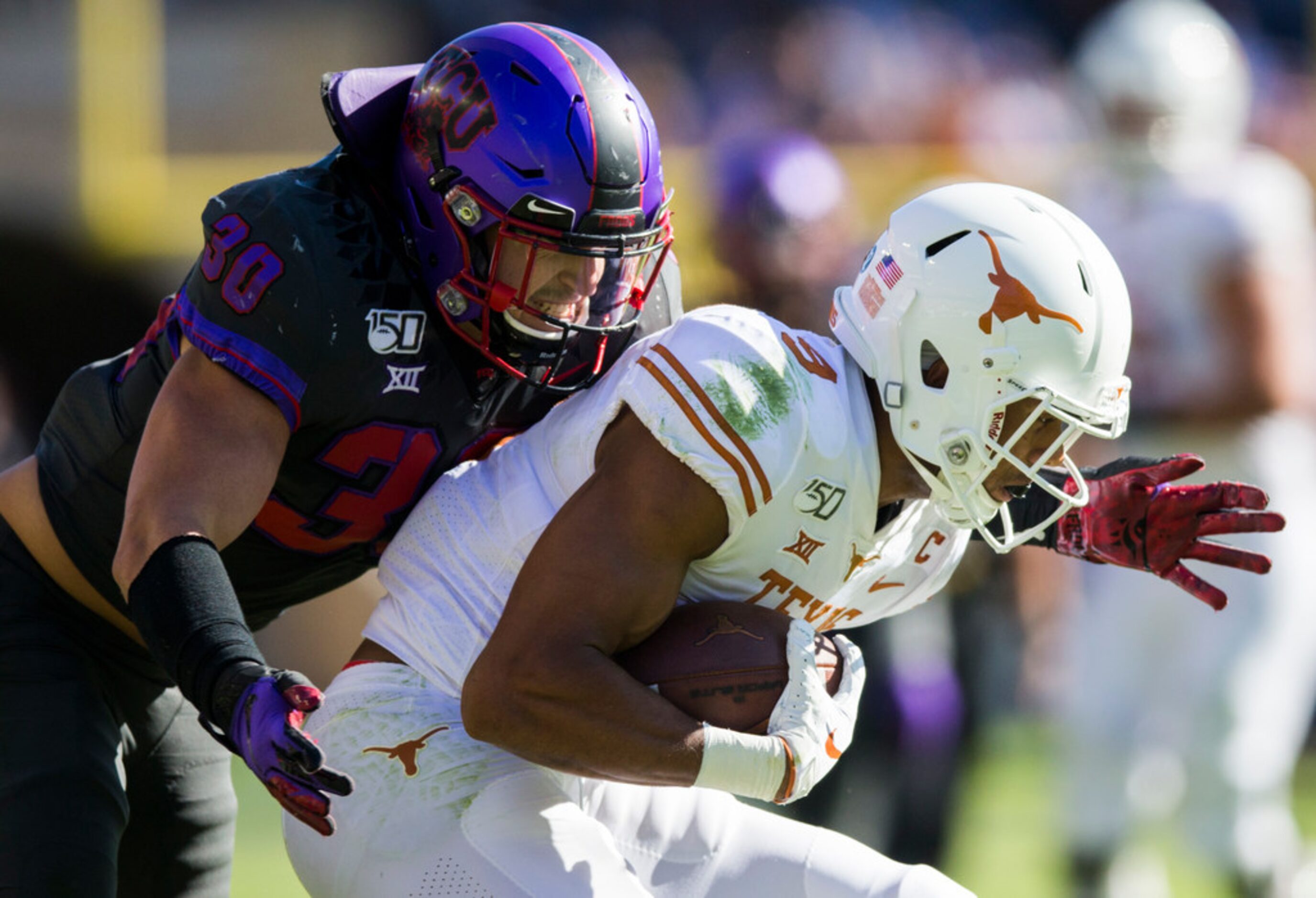 TCU Horned Frogs linebacker Garret Wallow (30) tackles Texas Longhorns wide receiver Collin...