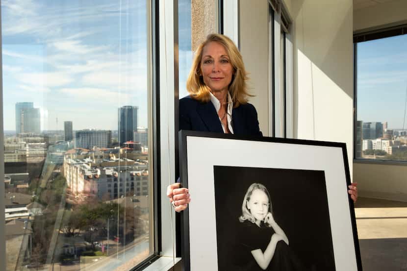 Terry Bentley Hill, with a photograph of her youngest daughter, Hallie, at her law office in...