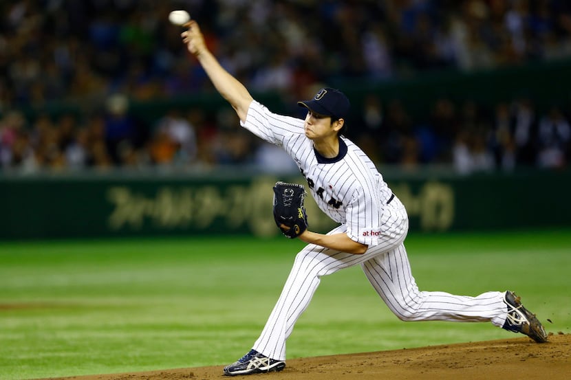 Japan s starter Shohei Otani pitches against South Korea during the first inning of their...