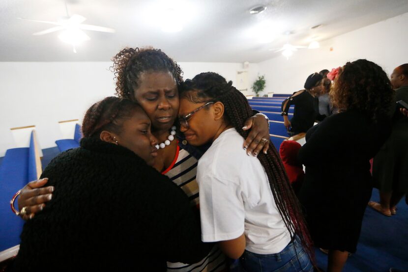 Beverly Oderbert (in stripes), mother of Mark Oderbert II, embraced Alexis Jackson (left)...