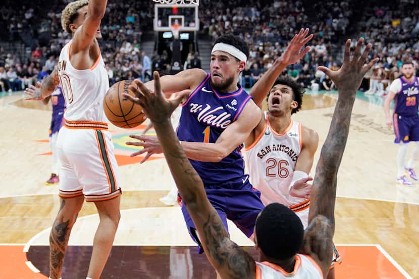 Phoenix Suns guard Devin Booker (1) drives to the basket past San Antonio Spurs forward...