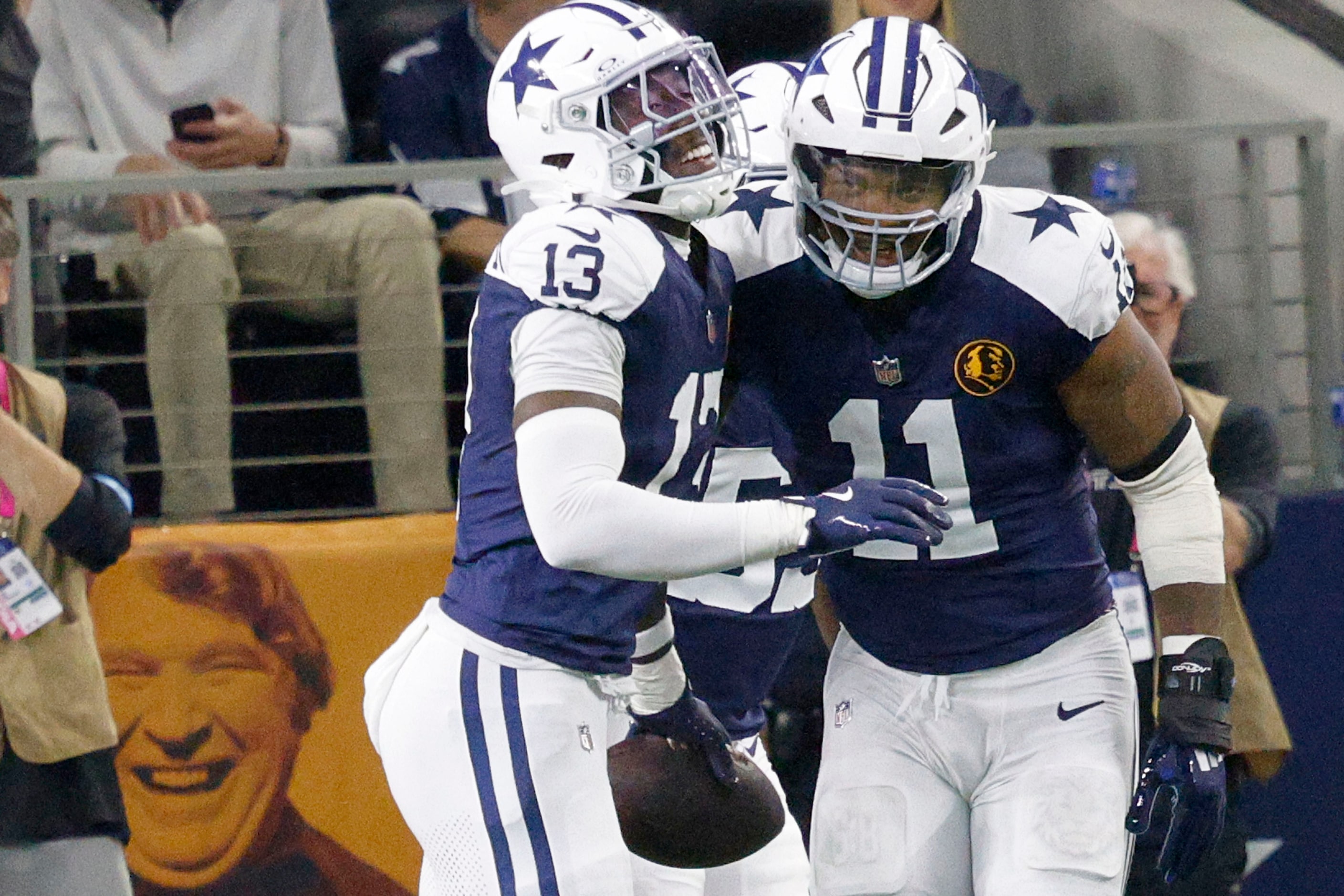 Dallas Cowboys linebacker DeMarvion Overshown (13)celebrates with his teammate linebacker...