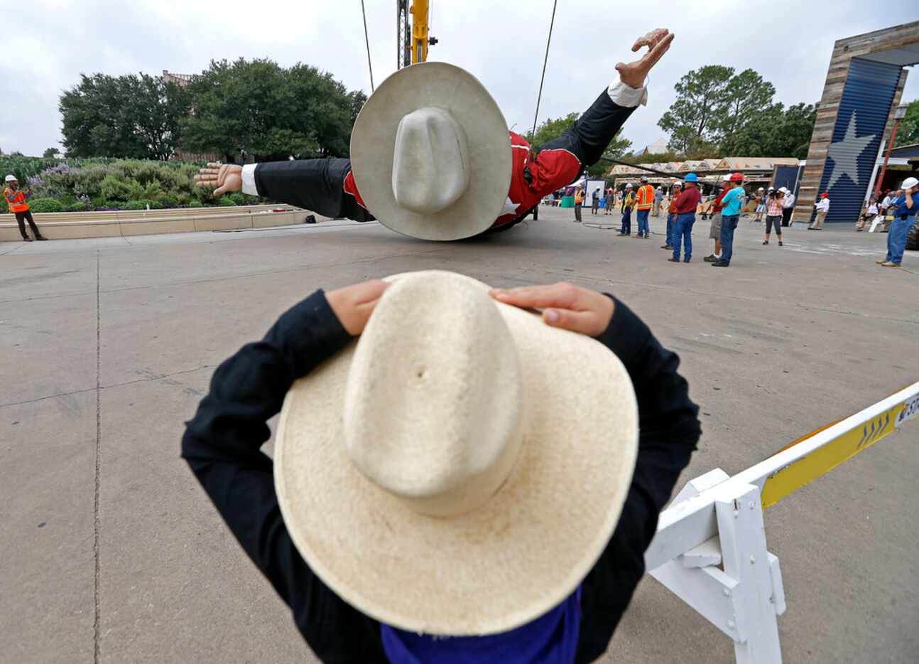 Christopher Hoffman, 8, watches Big Tex being installed at Big Tex Circle in Fair Park in...
