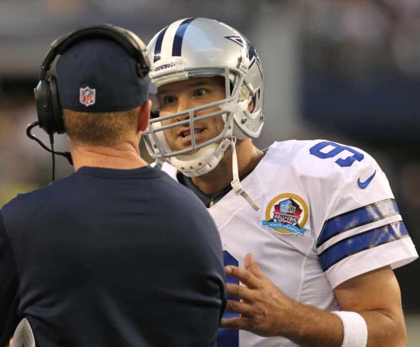 Dallas Cowboys quarterback Tony Romo (9) talks with Dallas Cowboys head coach Jason Garrett...