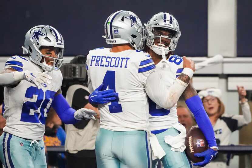 Dallas Cowboys wide receiver CeeDee Lamb (88) celebrates with quarterback Dak Prescott (4)...