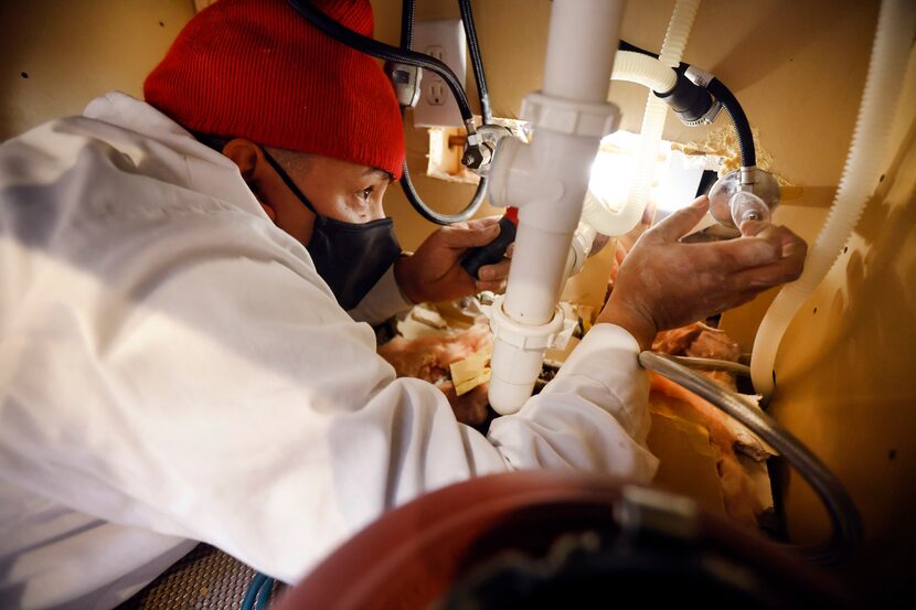 Marino makes repairs under Ellery's kitchen sink.