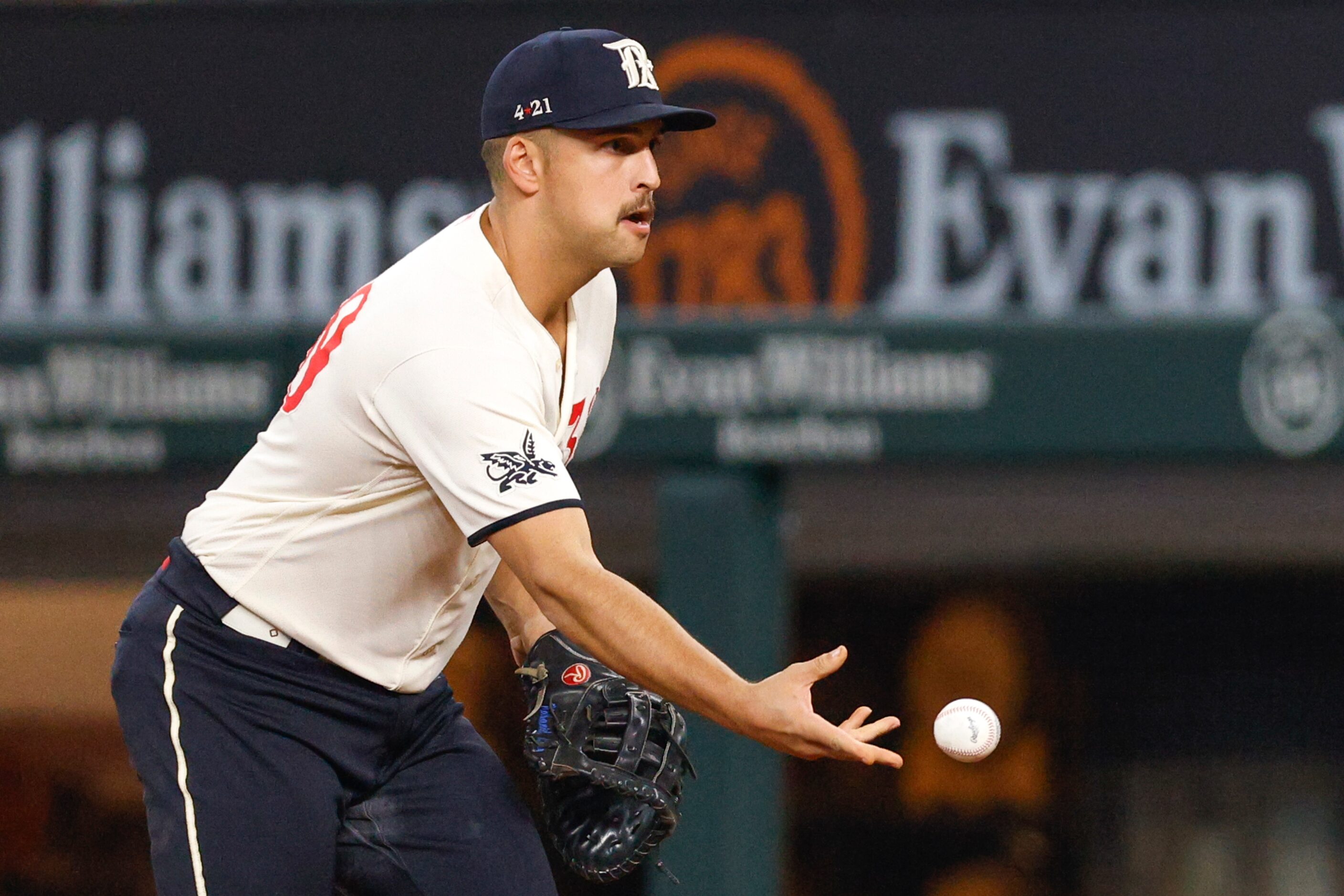 Texas Rangers first baseman Nathaniel Lowe (30) flips the ball to starting pitcher Jon Gray...