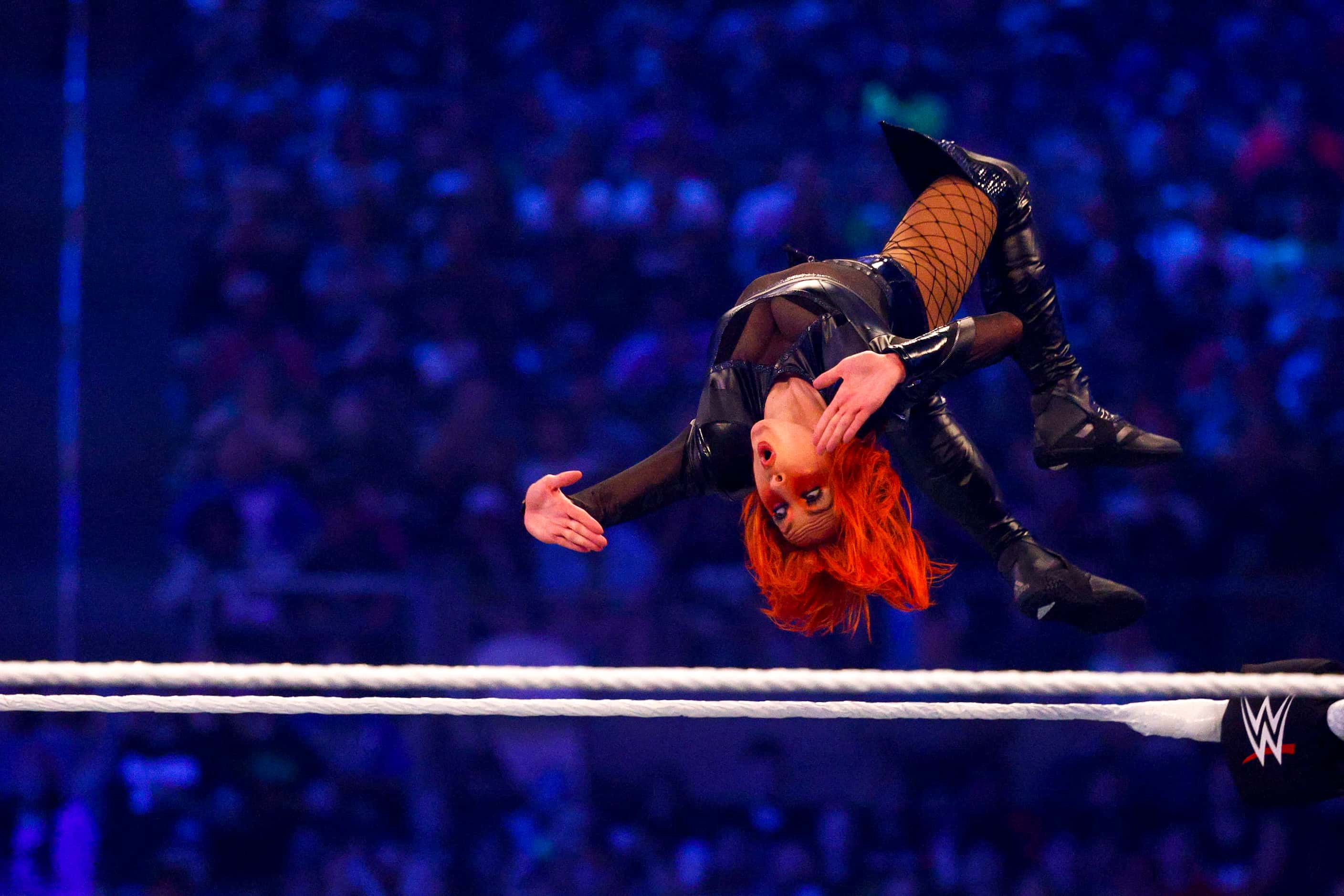 Becky Lynch flips off the ropes and onto Bianca Belair during the Raw Women's Championship...