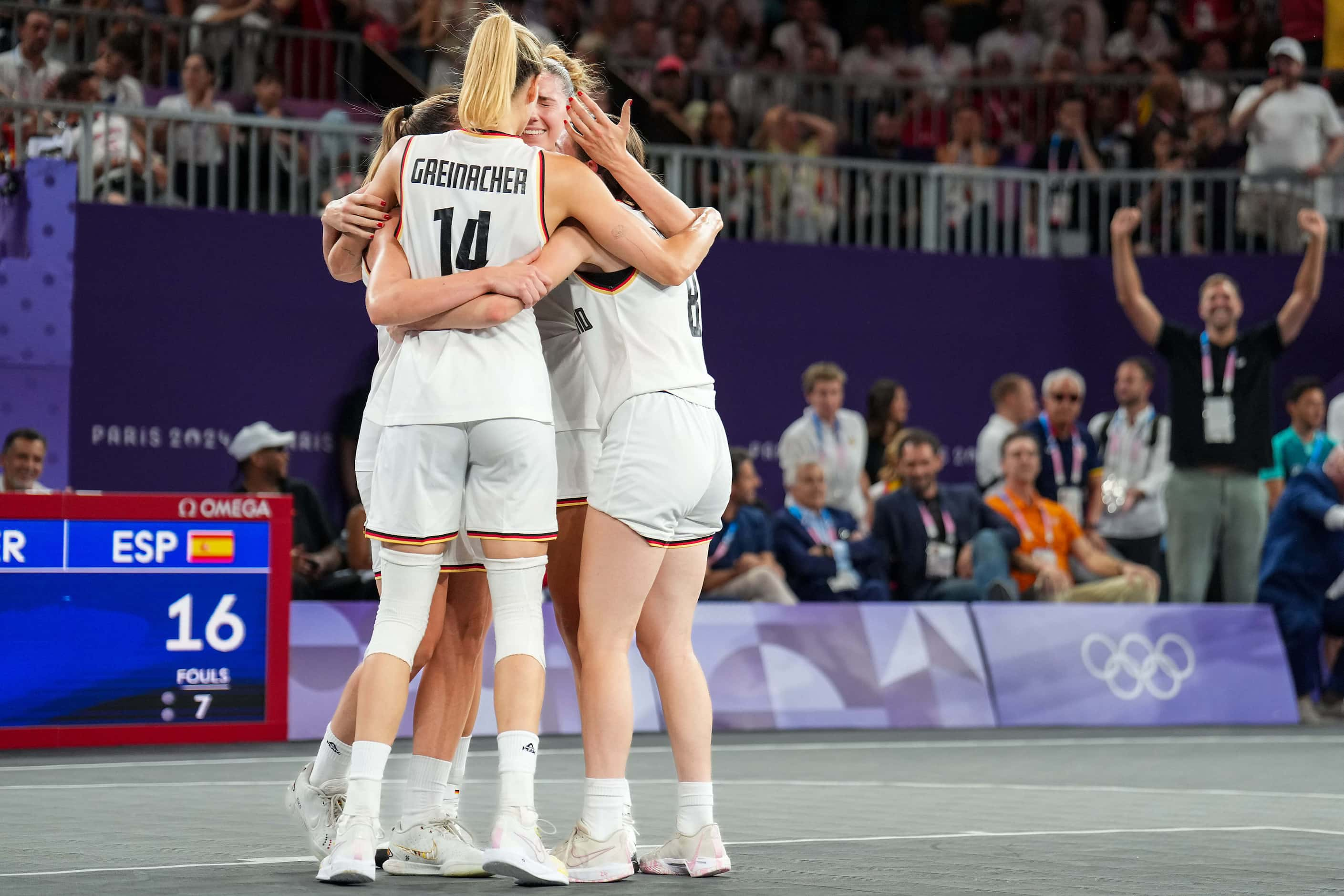 Dallas Mavericks great Dirk Nowitzki cheers in the background as Germany celebrates a win...