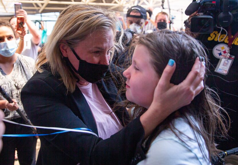 Dallas salon owner Shelley Luther hugs Savannah Holt, 10, of Garland after Luther was...