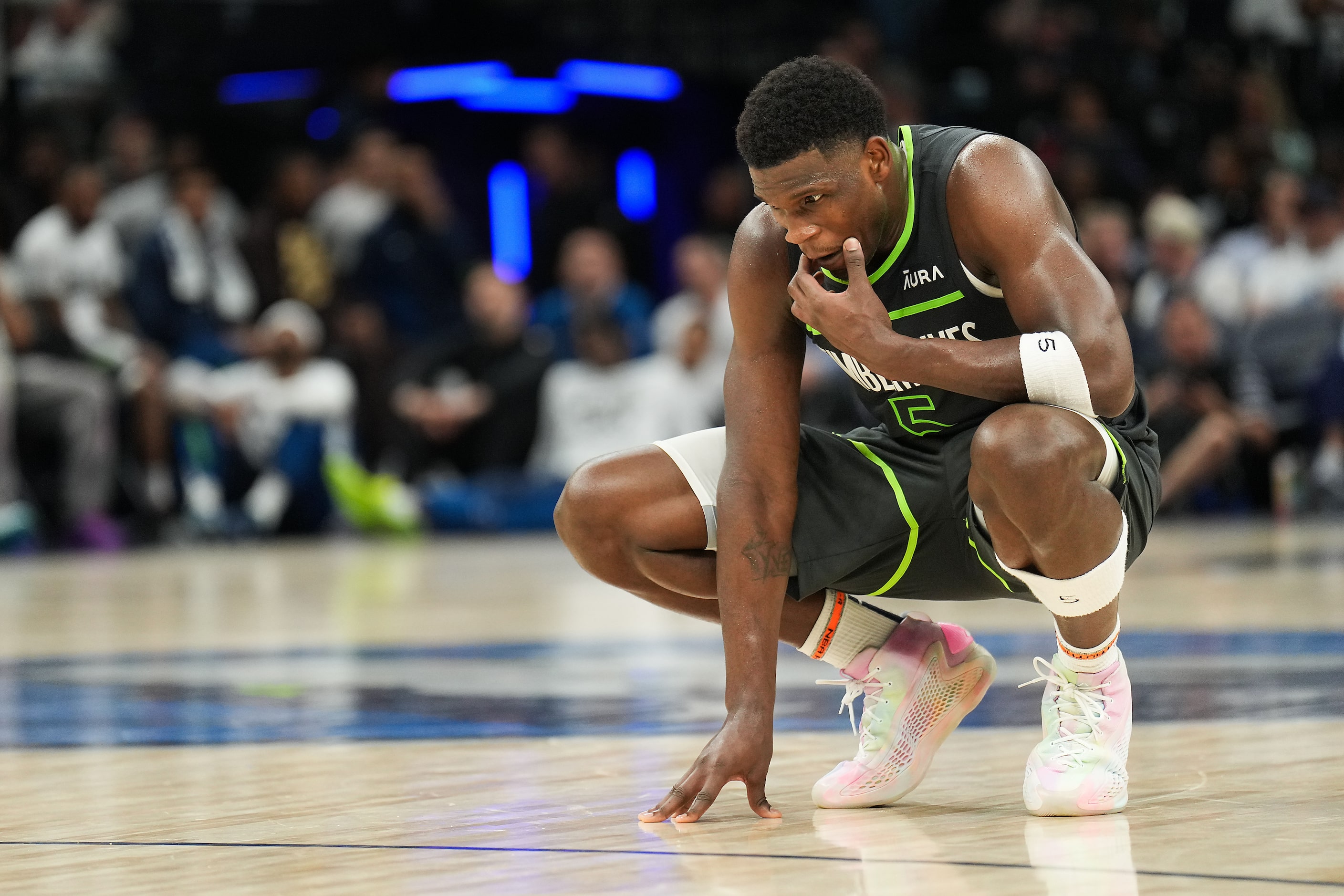 Minnesota Timberwolves guard Anthony Edwards pauses on the court during the second half in...