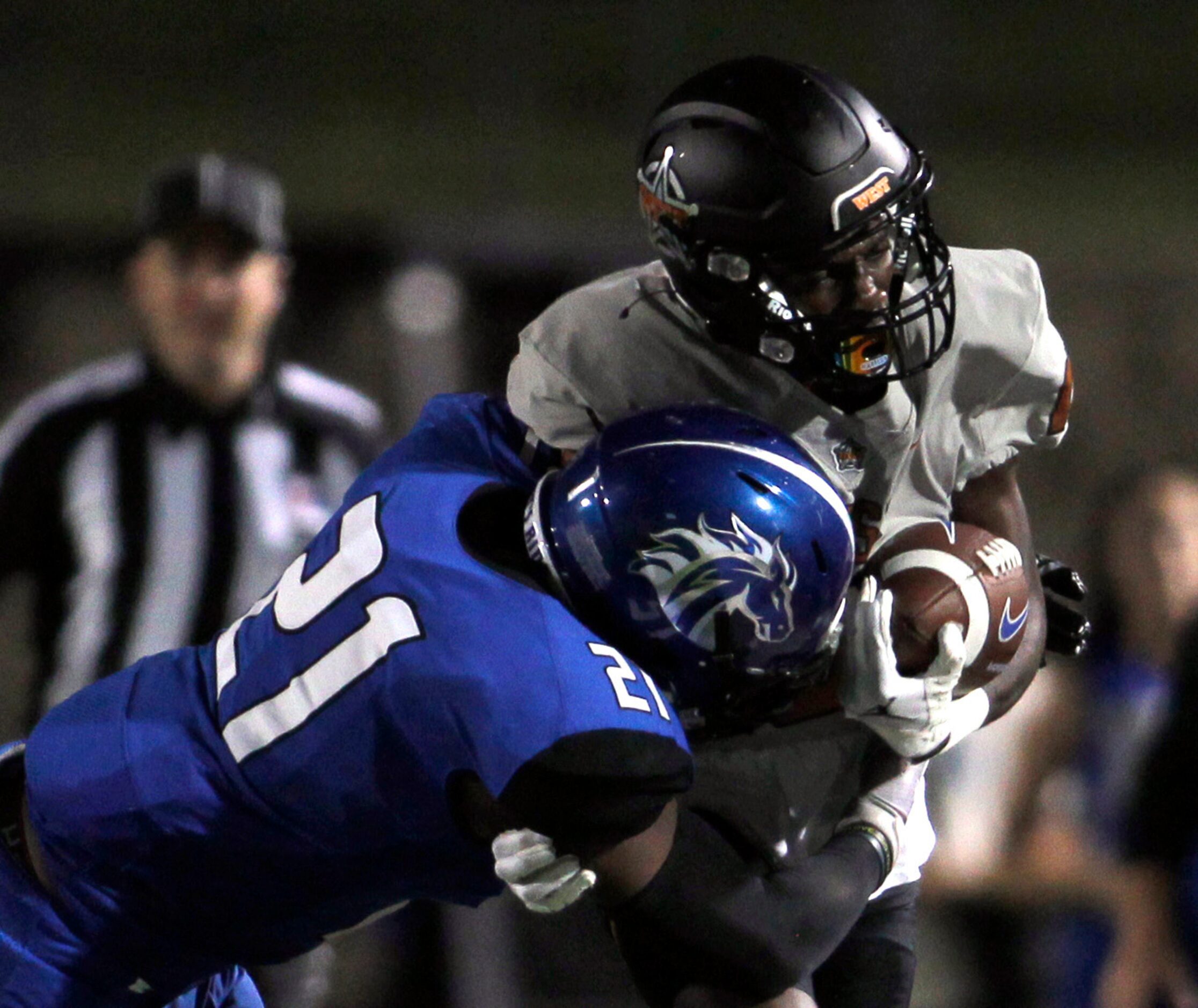 West Mesquite receiver Javion Jackson (10), right, is tackled by North Mesquite defender...