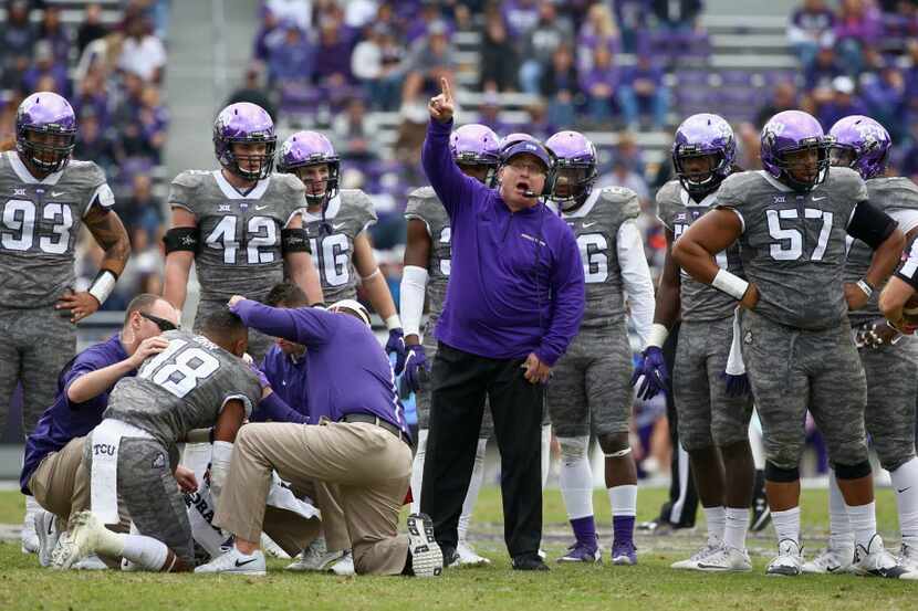 FORT WORTH, TX - NOVEMBER 14: Team trainers assist Nick Orr #18 of the TCU Horned Frogs...