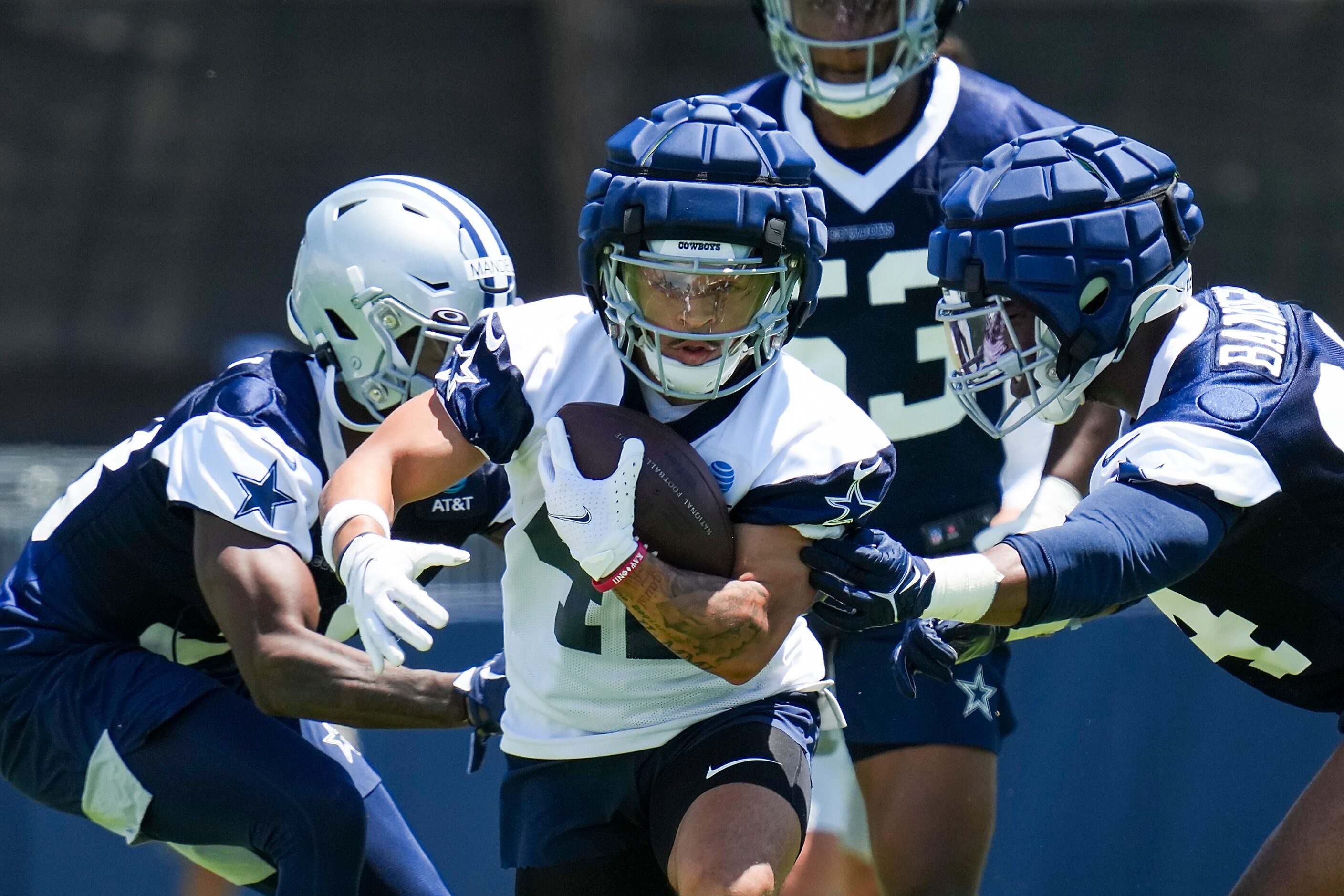 Dallas Cowboys running back Deuce Vaughn (42) carries the ball between defensive back...