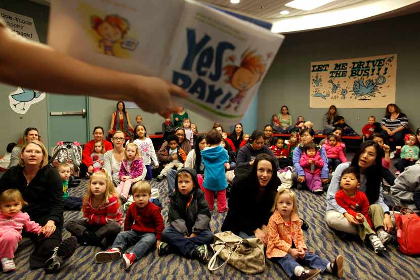 Frisco Library assistant Lisa Kilian reads "Yes Day!" to a group of toddlers during toddler...