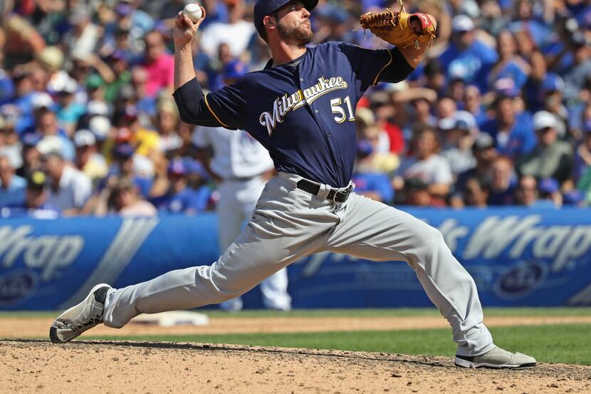 CHICAGO, IL - AUGUST 16:  Damien Magnifico #51 of the Milwaukee Brewers pitches against the...