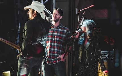 Brad Paisley hands the microphone to Clayton Kershaw, pitcher for the Los Angeles Dodgers,...