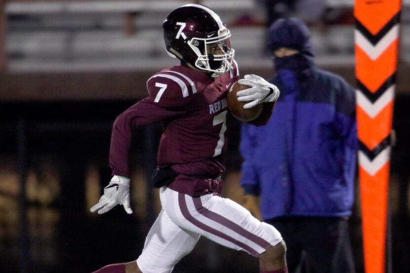 Red Oak wide receiver Raymond Gay scores a rushing touchdown against Seagoville on November...